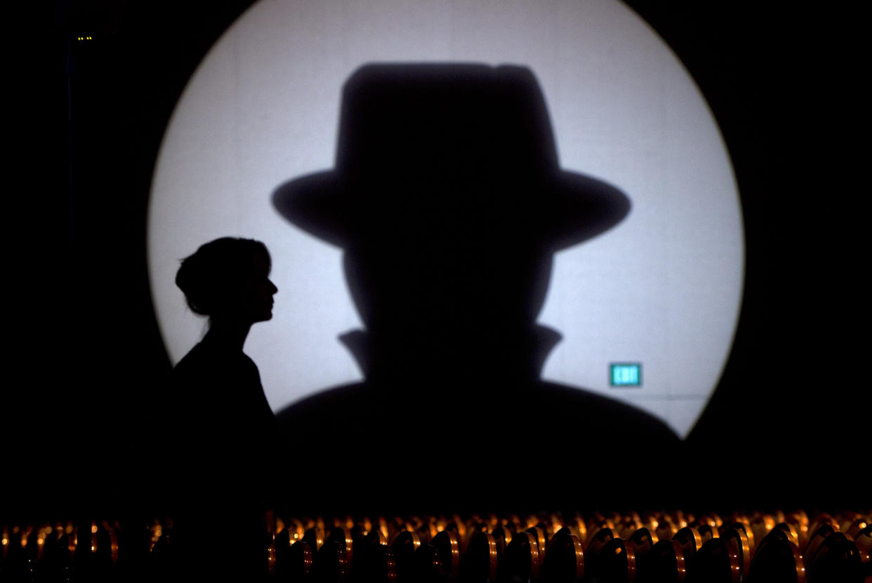 Speaker liaison Genevieve Netter is silhouetted against a Black Hat logo during the Black Hat USA 2014 hacker conference at the Mandalay Bay Convention Center in Las Vegas, Nevada August 6, 2014. REUTERS/Steve Marcus (UNITED STATES - Tags: SCIENCE TECHNOLOGY TPX IMAGES OF THE DAY)