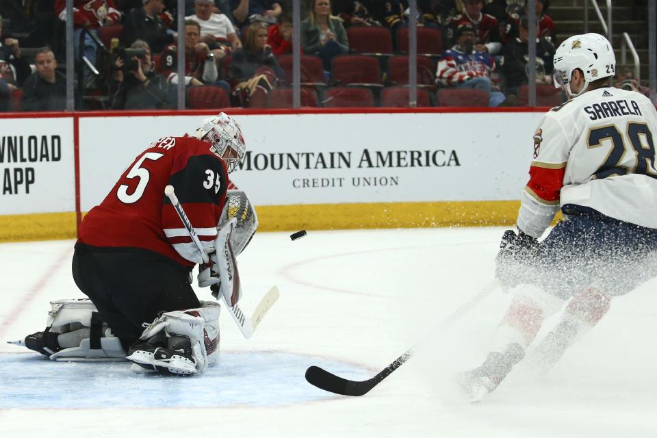 Arizona Coyotes goaltender Darcy Kuemper (35) makes a save on a shot by Florida Panthers center Aleksi Saarela (28) during the second period of an NHL hockey game Tuesday, Feb. 25, 2020, in Glendale, Ariz. (AP Photo/Ross D. Franklin)