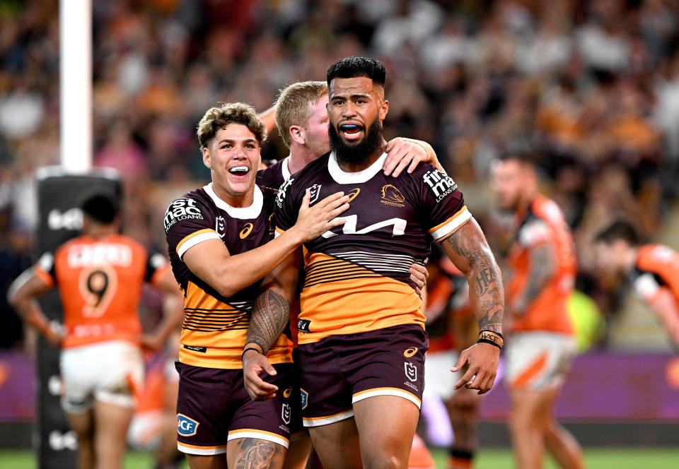 Pictured right, Payne Haas celebrating a try for the Broncos in round five of the NRL against the Wests Tigers.