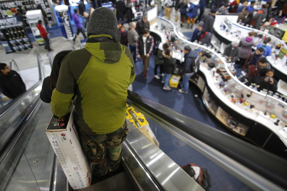 Customers shop at the Best Buy store, which opened at 1am, in Cambridge