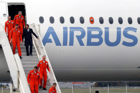 Flight test engineers speak with Airbus Chief Executive Officer Fabrice Bregier (C) after the maiden flight of the Airbus A350-1000 in Colomiers near Toulouse, Southwestern France, November 24, 2016. REUTERS/Regis Duvignau