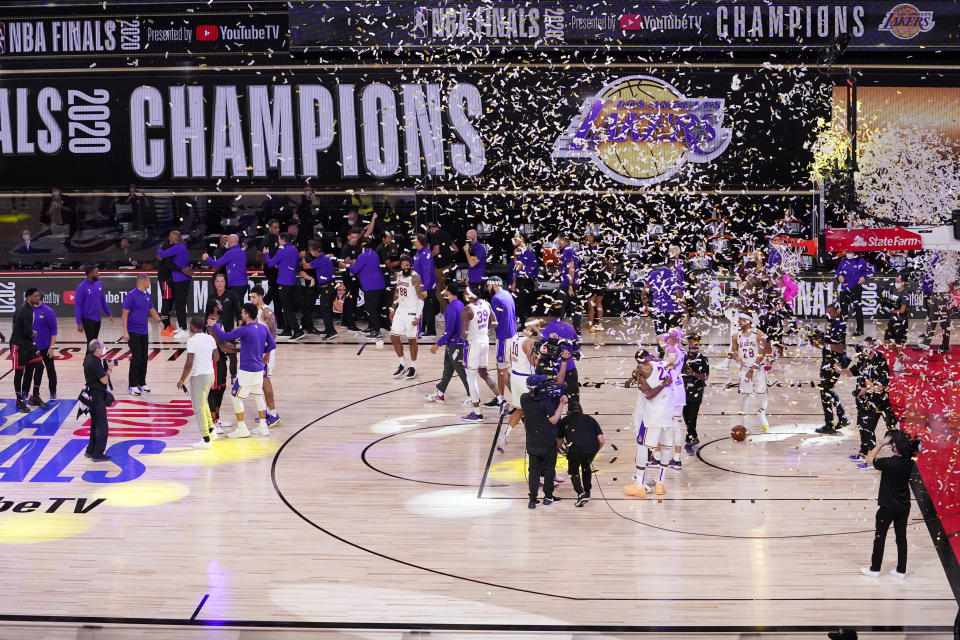 The Los Angeles Lakers players celebrate after the Lakers defeated the Miami Heat 106-93 in Game 6 of basketball's NBA Finals Sunday, Oct. 11, 2020, in Lake Buena Vista, Fla. (AP Photo/Mark J. Terrill)