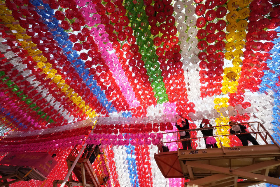 Workers hang lanterns for an annual festival celebrating the birthday of Buddha, at Jogye temple in Seoul, South Korea, Friday, May 10, 2024. (AP Photo/Ahn Young-joon)