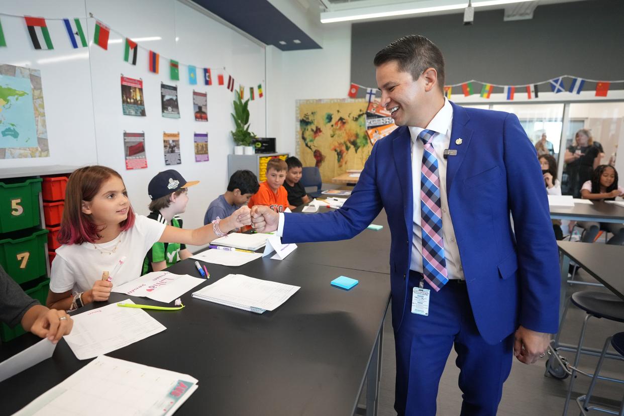 Austin school district interim Superintendent Matias Segura fist-bumps sixth grader Lilia Link, 11, on the first day of classes at Marshall Middle School on Aug. 14.