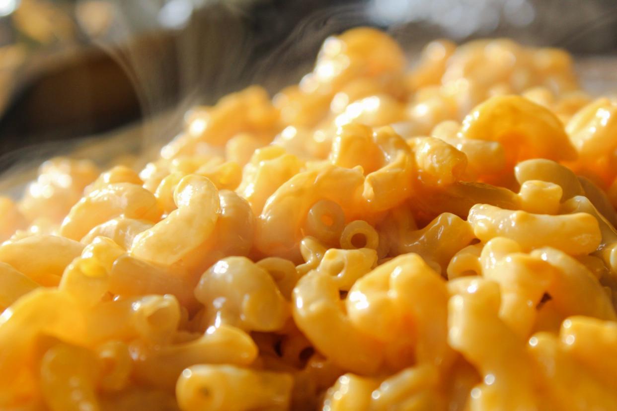 Steaming hot macaroni and cheese close up