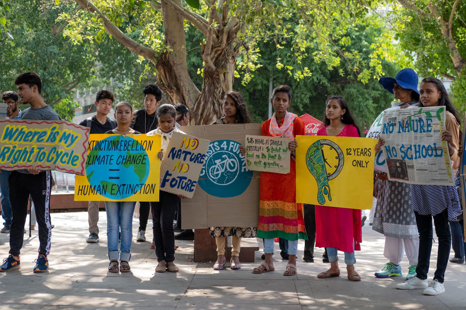 Indian students and school children hold placards as they participate in a global strike for urgent climate action in New Delhi on May 24, 2019. | Laurene Becquart—AFP/Getty Images