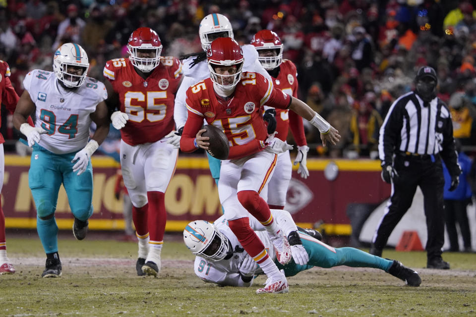 FILE -Kansas City Chiefs quarterback Patrick Mahomes (15) runs against Miami Dolphins defensive end Emmanuel Ogbah (91) during an NFL wild-card playoff football game Saturday, Jan. 13, 2024 in Kansas City, Mo. There are a variety of ways a game can change, and that’s been evident in the games that led to this week’s Super Bowl matchup between Kansas City and San Francisco.(AP Photo/Ed Zurga, File)