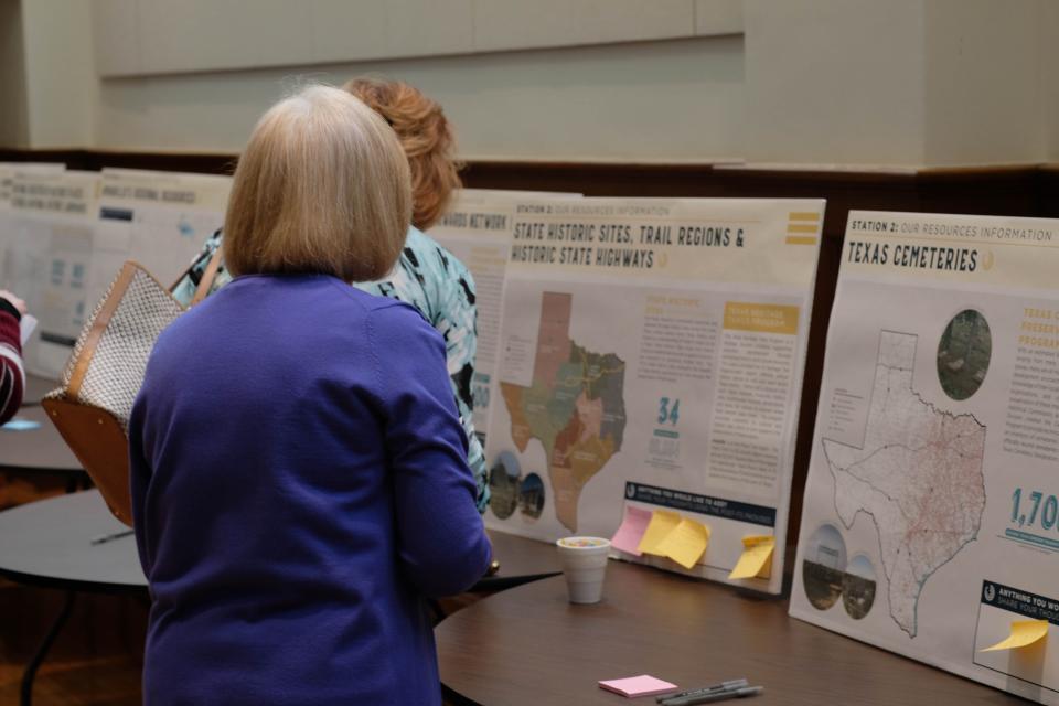 Guests at the Texas Historical Commission's preservation event look over the interactive displays at the Sante Fe Building Auditorium Thursday.