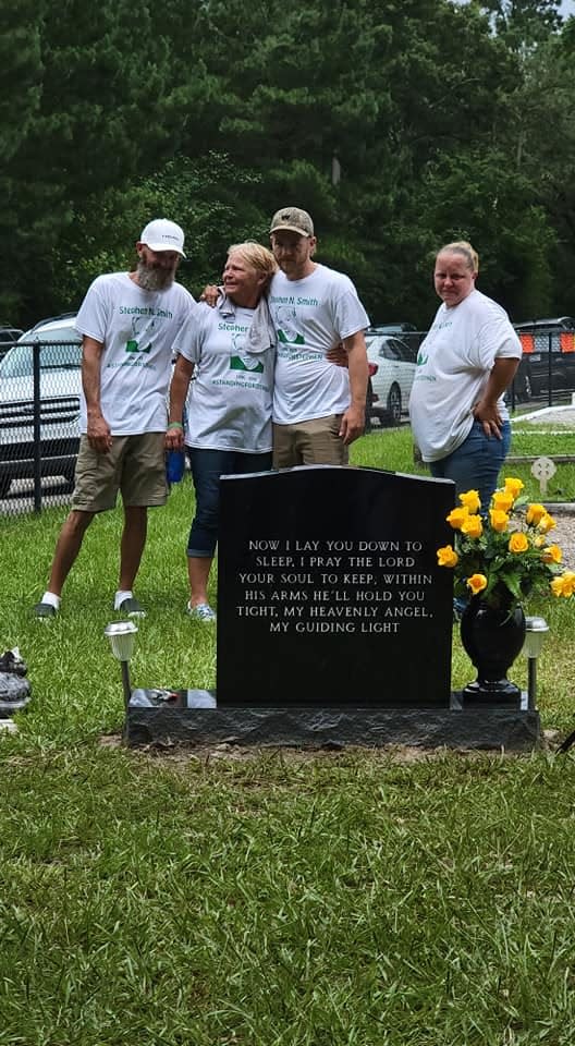 Members of the Smith family hold each other during the memorial service.