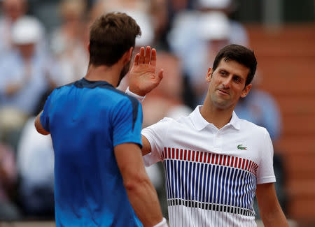 Tennis - French Open - Roland Garros, Paris, France - 29/5/17 Serbia's Novak Djokovic shakes the hand of Spain's Marcel Granollers as he celebrates winning his first round match Reuters / Gonzalo Fuentes