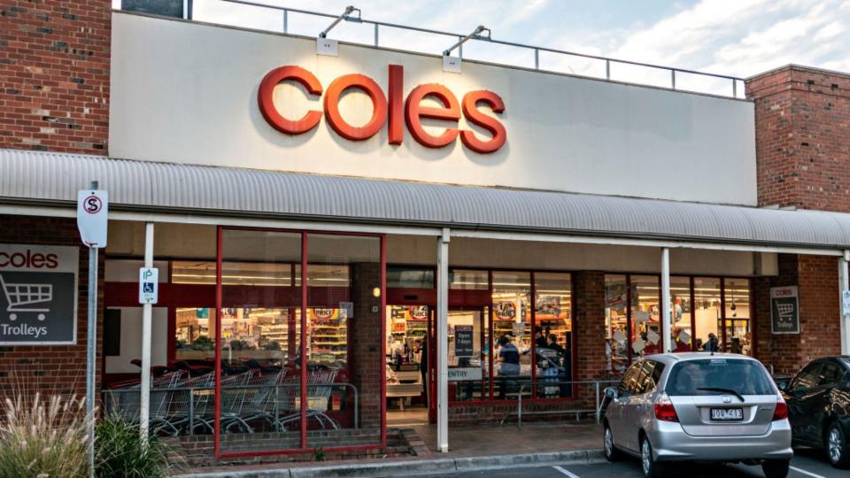 Exterior of Coles supermarket with car parked in carpark. 