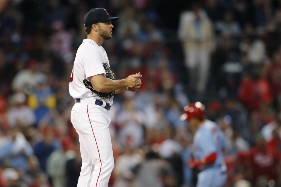 Boston Red Sox's Kutter Crawford, left, looks to the outfield after giving up a solo home run to St. Louis Cardinals' Nolan Gorman, back right, during the fourth inning of a baseball game, Saturday, June 18, 2022, in Boston. (AP Photo/Michael Dwyer)