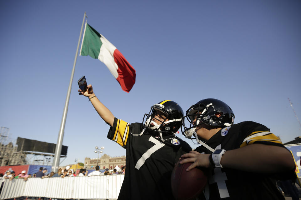 Fans pose wearing Steelers uniforms during NFL football's Fan Fest in Mexico City's main square, the Zocalo. (AP)