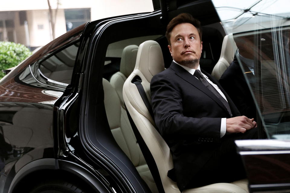 Tesla Chief Executive Officer Elon Musk gets in a Tesla car as he leaves a hotel in Beijing, China May 31, 2023. REUTERS/Tingshu Wang