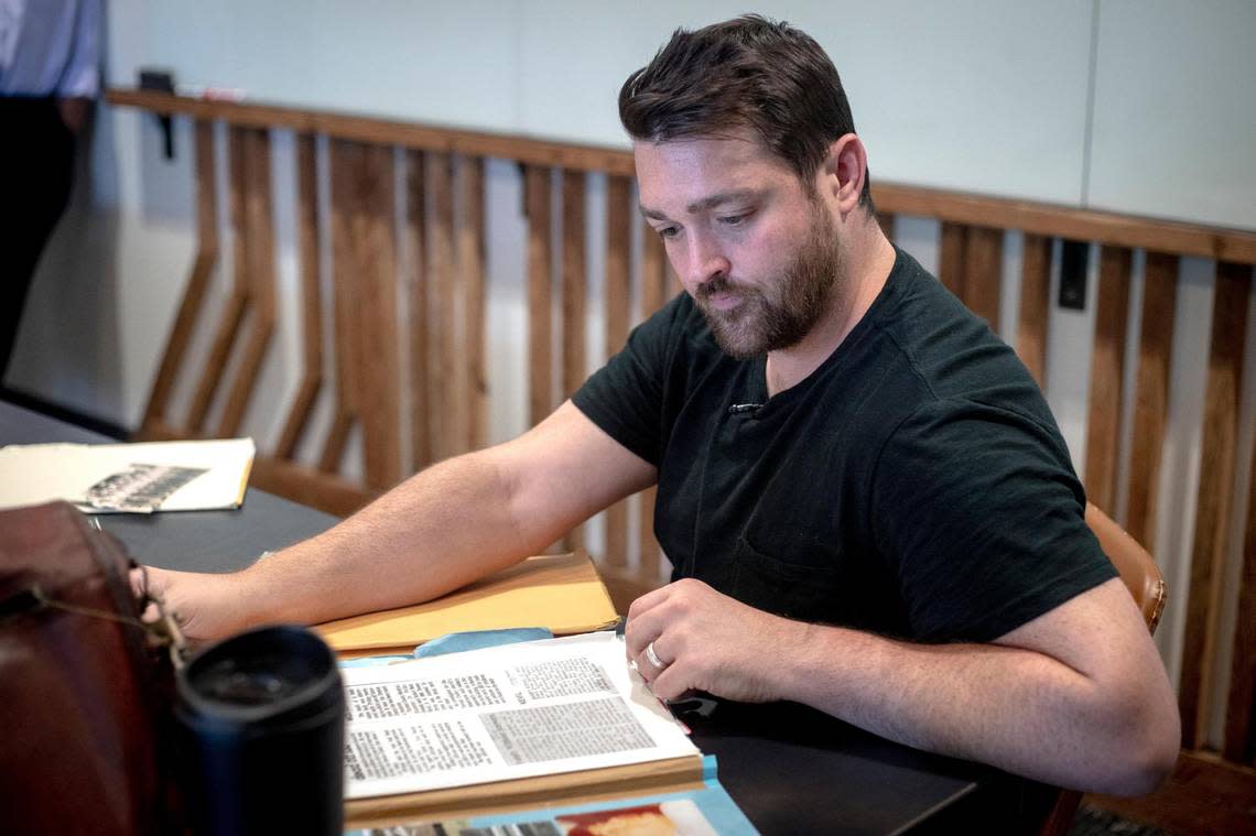 Private investigator Matt Budjenska flips through documents he gathered to research the 1977 slaying of Robert Matt Kevil Jr., in Fort Worth, Texas, on July 13, 2022. Budjenska was hired in 2020 to investigate the cold case after no arrests were made for decades.