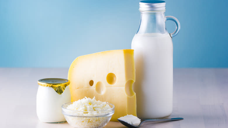 Cheese and a glass bottle of milk with other dairy products