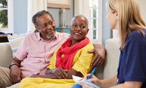 Older couple smiling during a discussion