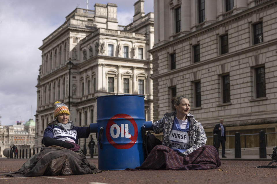 LONDON, ENGLAND - APRIL 07: Extinction Rebellion (XR) protesters glue themselves to barrels outside the Treasury on April 07, 2022 in London, England. The UK government released their energy strategy today placing nuclear power and continued oil and gas exploitation at the heart of the policy. (Photo by Dan Kitwood/Getty Images)