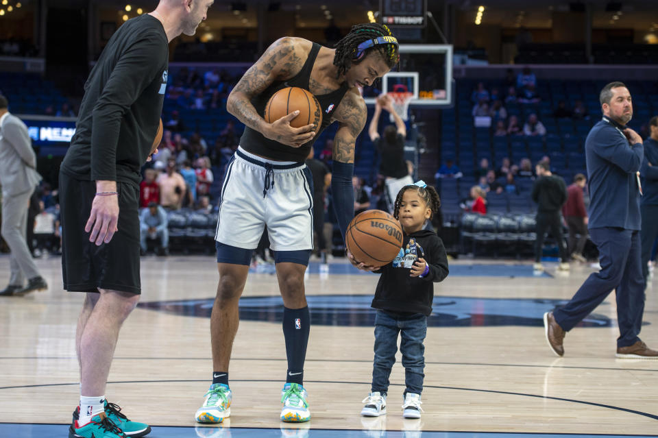 CORRECTS SPELLING OF DAUGHTERS NAME TO KAARI - Memphis Grizzlies guard Ja Morant warms up with his daughter Kaari Morant, 3, before an NBA basketball game against the Houston Rockets, Wednesday, March 22, 2023, in Memphis, Tenn. (AP Photo/Brandon Dill)