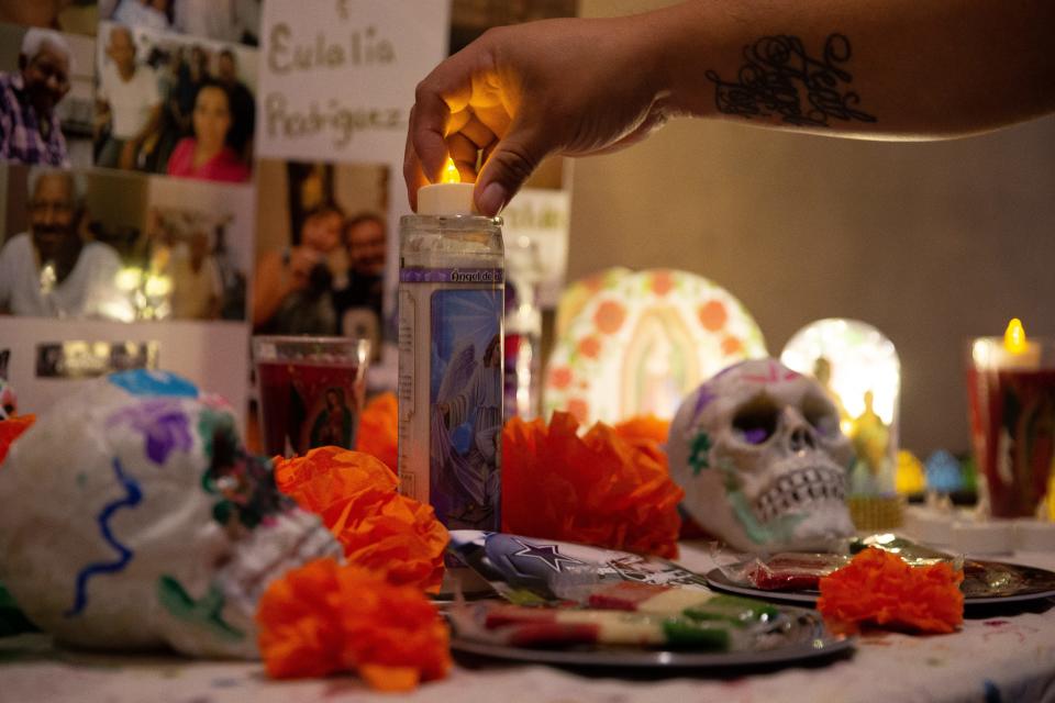 Fermin and Lori Sanchez decorate an ofrenda for family members at The Ritz Theater in Corpus Christi on Saturday, Oct. 23, 2021.