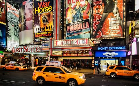 The lights of Broadway with New York's yellow cabs in the foreground