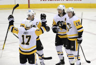 Pittsburgh Penguins center Jared McCann (19) celebrates his goal with teammates during the first period of an NHL hockey game against the New Jersey Devils on Friday, April 9, 2021, in Newark, N.J. (AP Photo/Bill Kostroun)