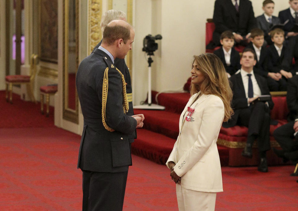 Rapper and singer MIA, real name Mathangi Arulpragasam, is made an MBE by Prince William Duke of Cambridge, left, at Buckingham Palace, in London, Tuesday Jan. 14, 2020. The honorary award is conferred in recognition of contributions to the arts, sport, sciences, and charitable works. (Jonathan Brady/PA via AP)