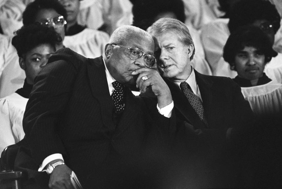 FILE - The Rev. Martin Luther King Sr. and President Jimmy Carter, right, confer during a ceremony in Atlanta on Jan. 14, 1979, to present the Dr. Martin Luther King Jr. Non-Violent Peace Prize to Carter. (AP Photo/Jim Wells, File)