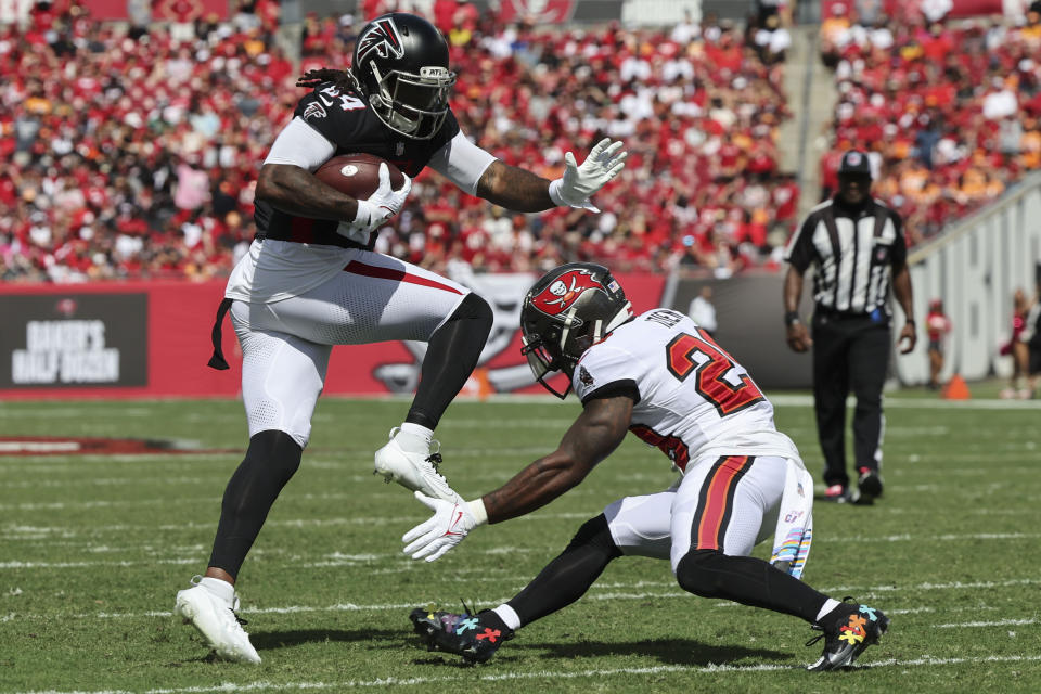 Atlanta Falcons running back Cordarrelle Patterson (84) runs against Tampa Bay Buccaneers safety Christian Izien (29) during the first half of an NFL football game, Sunday, Oct. 22, 2023, in Tampa, Fla. (AP Photo/Mark LoMoglio)