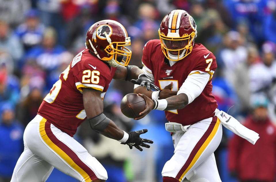 Washington Redskins quarterback Dwayne Haskins (7) hands the ball off to running back Adrian Peterson (26) during the first half of an NFL football game against the Buffalo Bills, Sunday, Nov. 3, 2019, in Orchard Park, N.Y. (AP Photo/Adrian Kraus)