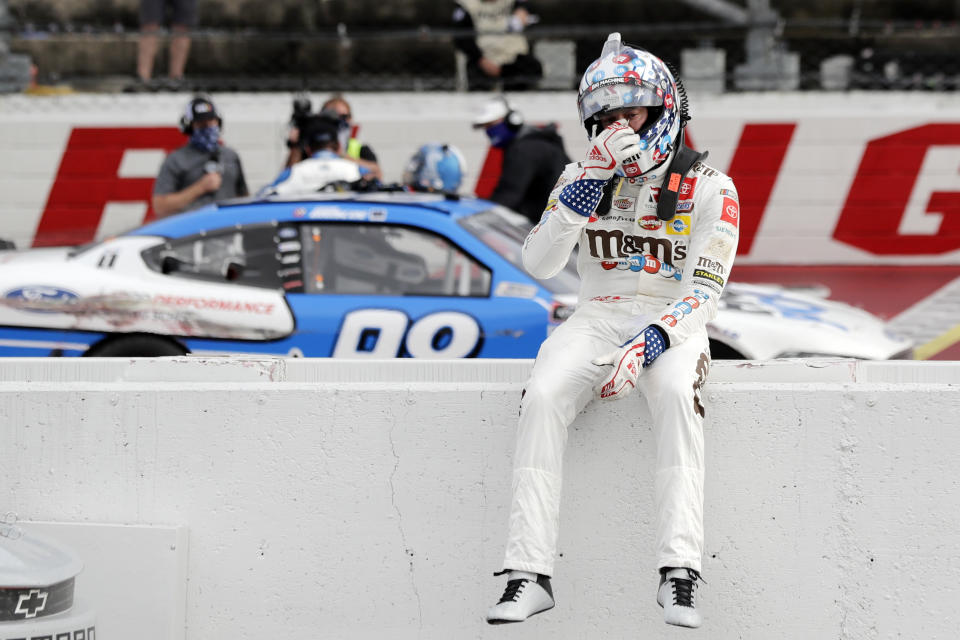 Kyle Busch sits on the wall as Chase Briscoe celebrates behind him after Briscoe edged out Busch to win the NASCAR Xfinity series auto race Thursday, May 21, 2020, in Darlington, S.C. (AP Photo/Brynn Anderson)