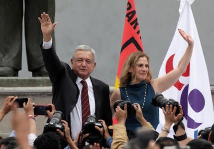 Leftist front-runner Andres Manuel Lopez Obrador, accompanied by his wife Beatriz Gutierrez Mueller, greets his supporters after being registered as a presidential candidate of the National Regeneration Movement (MORENA) in Mexico City, Mexico March 16, 2018. REUTERS/Henry Romero