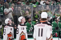 Dallas Stars left wing Jamie Benn center, acknowledges applause from fans after it was announced that he is skating in his 1,000th career game, in the first period of an NHL hockey game against the Anaheim Ducks, Monday, Feb. 6, 2023, in Dallas. (AP Photo/Tony Gutierrez)