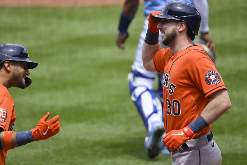 The Houston Astros' Kyle Tucker, right, is congratulated by teammate Yuli Gurriel, left, after hitting a home run against the Kansas City Royals during the fourth inning of a baseball game, Sunday, June 5, 2022, in Kansas City, Mo. (AP Photo/Reed Hoffmann)