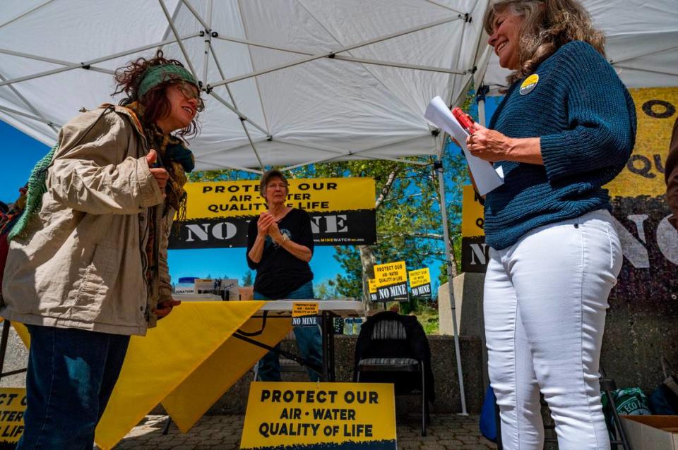Idaho-Maryland Mine opponents Nicole Lazio, left, Kathy Ogburn, center, and Tracie Sheehan converse in one of the opposition tents set up outside the Nevada County administration center on May 11 for the second day of planning commission hearings on the project.