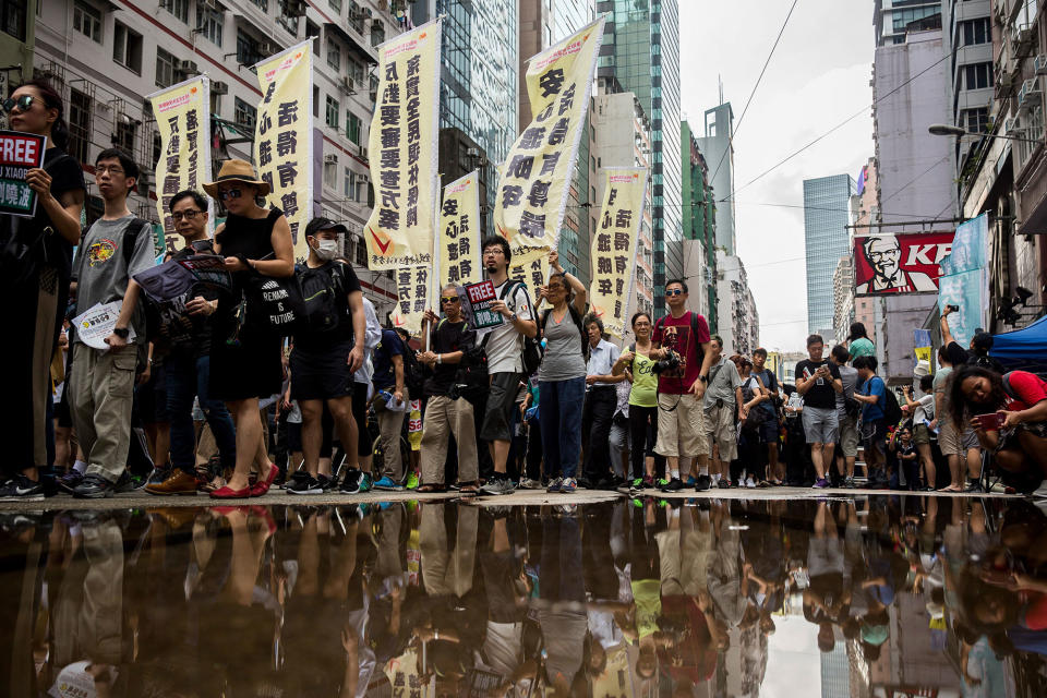 <p>People attend a protest march in Hong Kong on July 1, 2017, coinciding with the 20th anniversary of the city’s handover from British to Chinese rule. (Photo: Isaac Lawrence/AFP/Getty Images) </p>