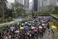 Hundreds of accountants march at Chater Garden in Hong Kong, Friday, Aug. 23, 2019. Protesters demand the government to fully withdraw the extradition bill and set up an independent committee to investigate the use of force by the Hong Kong police. (AP Photo/Kin Cheung)