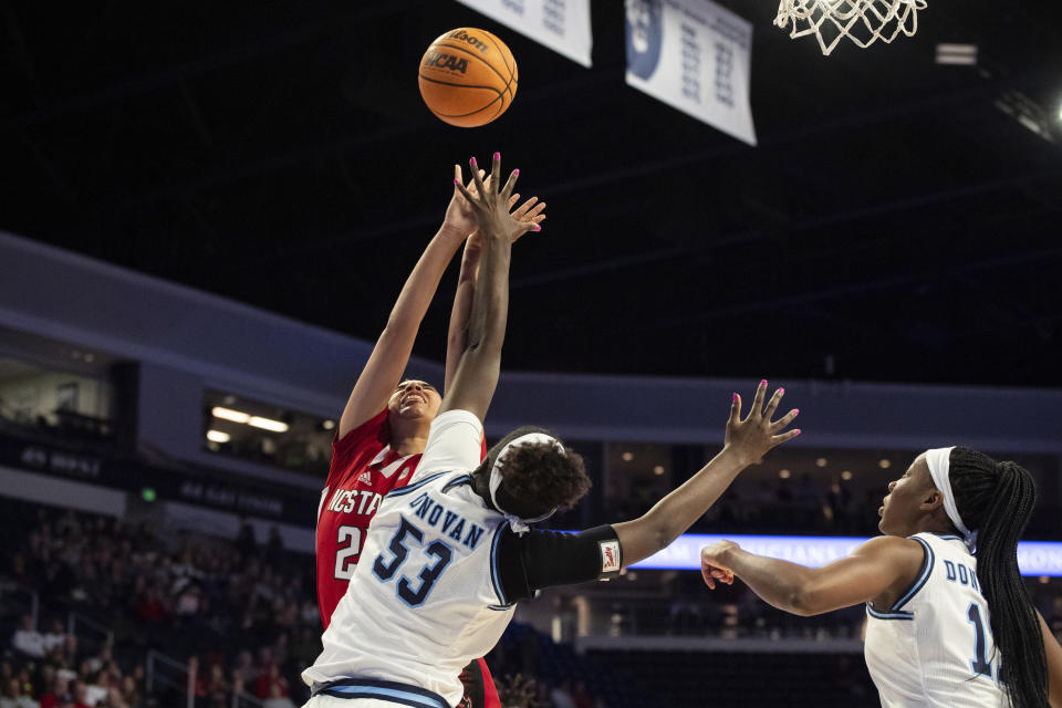 North Carolina State guard Madison Hayes (21) shoots against Old Dominion forward Lanetta Williams (53) during the first half of an NCAA college basketball game Wednesday, Dec. 20, 2023, in Norfolk, Va. (AP Photo/Mike Caudill)