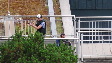 A screen grab taken from video footage shows plain clothes police officers at the scene of a shooting rampage at the Olympia shopping mall in Munich, Germany July 22, 2016. dedinac/Marc Mueller/ handout via REUTERS