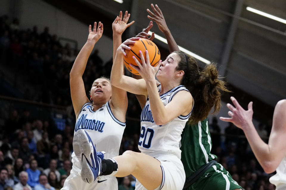 Villanova's Maddy Siegrist, center and Kaitlyn Orihel, left, win the rebound over Cleveland State's Amele Ngwafang, back, during the first half of a first-round college basketball game in the NCAA Tournament, Saturday, March 18, 2023, in Villanova, Pa. (AP Photo/Matt Rourke)