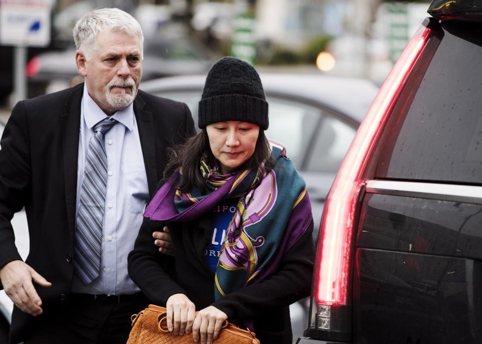 Huawei chief financial officer Meng Wanzhou arrives at a parole office with a security guard in Vancouver, British Columbia on Wednesday. (Photo: Darryl Dyck/Canadian Press via AP)