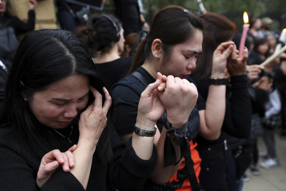 Women from the Philippines react, outside of the presidential palace in Nicosia, Cyprus, Friday, April 26, 2019. Up to 1,000 people turned out in front of Cyprus' presidential palace to remember the five foreign women and 2 girls that a military officer has confessed to killing in what police are again calling "an unprecedented crime." (AP Photo/Petros Karadjias)