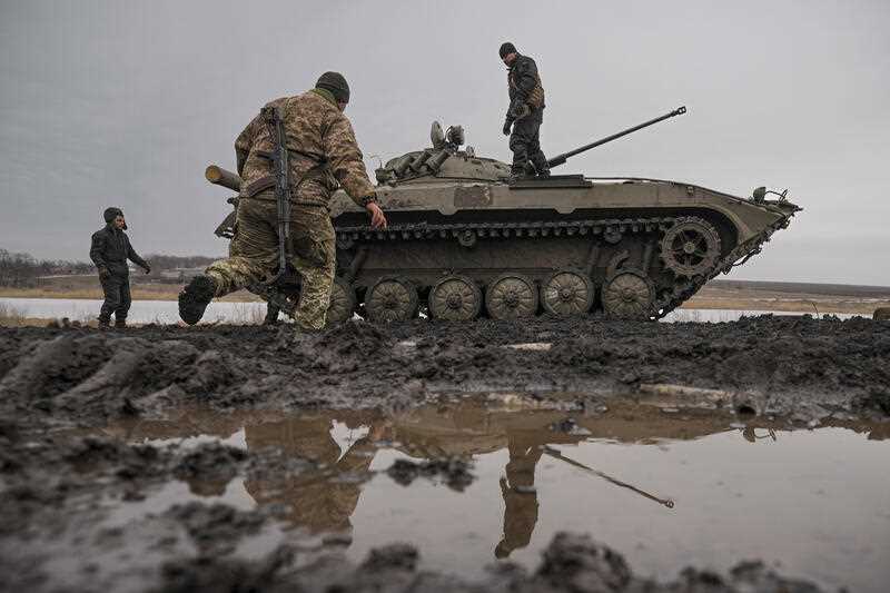 Ukrainian servicemen walk on an armoured fighting vehicle during an exercise in a Joint Forces Operation controlled area in the Donetsk region.