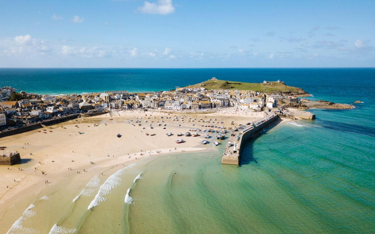 St Ives, a wide sandy beach and sheltered harbour with boats beach on sand at low tide. - Ben Pipe Photography