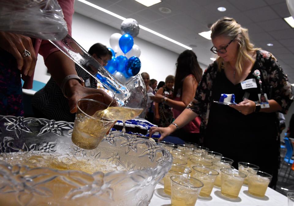 Punch is poured for employees and guests as the Abilene Blue Cross Blue Shield marked 25 years May 17.