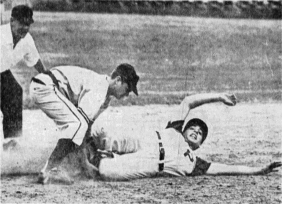 Lou Sette of Paramus slides safely into third base while Bob Anderson of Leonia applies tag. Sette hit two triples and drove in three runs in helping the Spartans to a 9-1 victory in Bergen County baseball final. Originally published in The Record, June 8, 1964, page 50