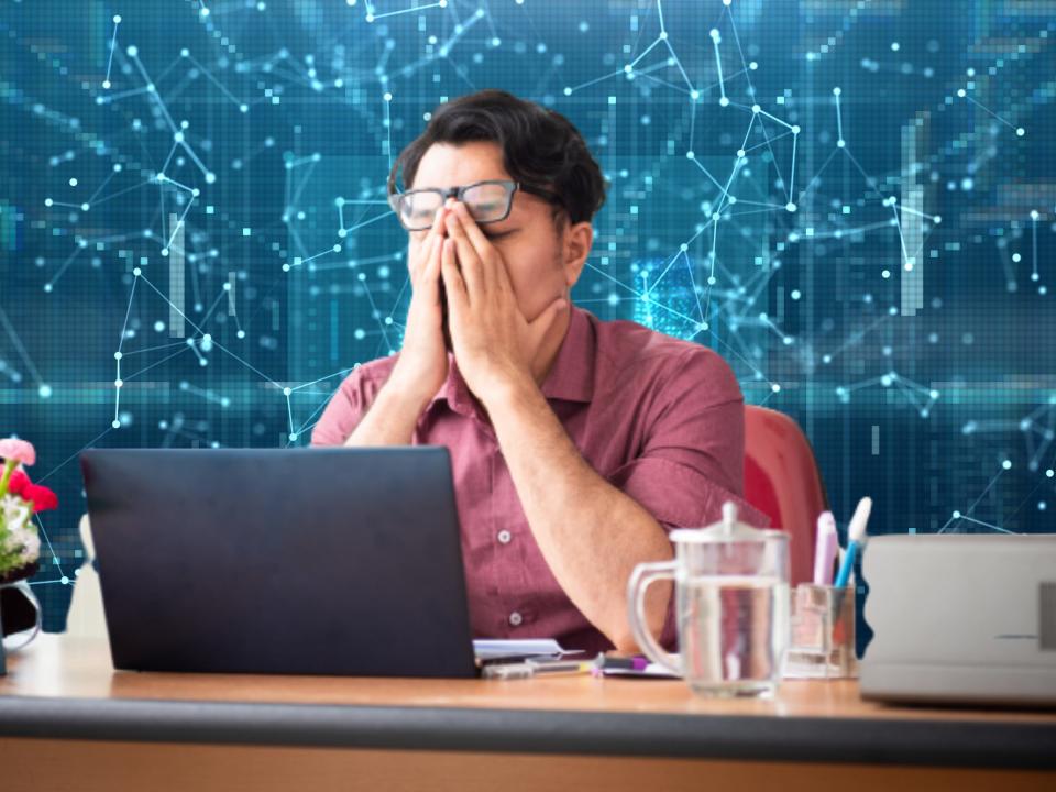 Composite image of stressed out worker on tech background