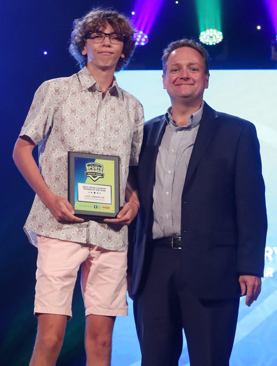 Walsh Jesuits' Luke Ondracek Greater Akron Boys Cross Country Player of the Year with Michael Shearer Akron Beacon Journal editor at the High School Sports All-Star Awards at the Civic Theatre in Akron on Friday.