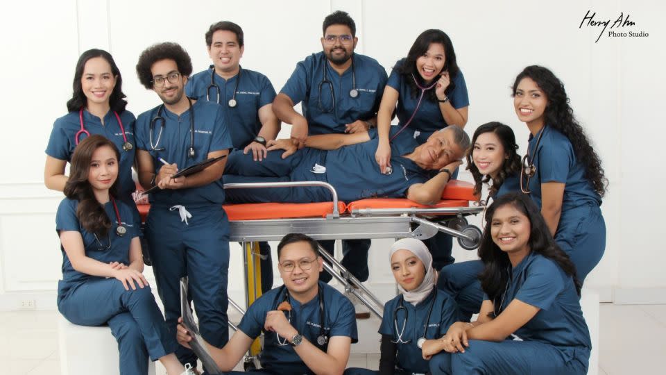 Posing on a stretcher, Toh and his cohort completed medical school together. - Toh Hong Keng/Henry Ahn Photo Studio