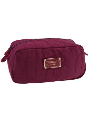 An oversize topstitched logo and metal nameplate make this cosmetic bag so cool. The nylon fabric, meanwhile, is durable and cleans up easily.